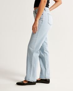 Our Curve Love 90's-style jeans in a light wash with a distressed hem. This fit features a 9.5” mid rise, is fitted at the waist and hips, and eases at the thigh into a straight, full-length leg shape. Our Curve Love styles add an additional 2” at the hip and thigh to allow room for your curves and eliminate waist gap. This jean is made from our vintage stretch fabric which features both an authentic vintage look and contains slight built-in stretch for additional comfort. Everyday Light Wash Flare Jeans With Frayed Hem, Classic Faded Bottoms For Spring, Everyday Flare Jeans With Frayed Hem, Everyday Full Length Flare Jeans With Frayed Hem, Light Wash Relaxed Fit Mid-rise Flare Jeans, Spring Flare Jeans With Frayed Hem, Classic Light Wash Pants For Spring, Everyday Light Wash Relaxed Fit Flare Jeans, Faded Bottoms With Standard Cut Leg For Spring