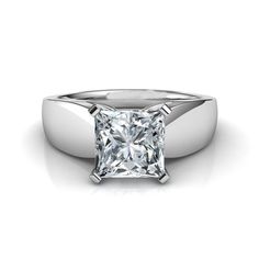 a white gold ring with a princess cut diamond in the center, on a white background