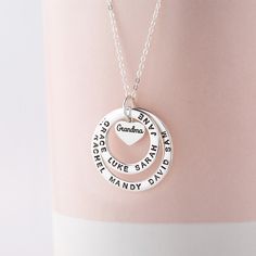 "This 100% Sterling Silver necklace is a meaningful and sweet gift for grandma, with her being in the centre on a heart charm and grandkids' names surrounding her. A perfect gift for Grandma on any occasion. PRODUCT INFO * Materials: 925 sterling silver with 18K yellow gold or rose gold plated options.  * Small ring measures approx. 3/4\" (20mm). Big ring measures approx. 1\" (26mm). Heart charm approx. 0.37\" x 0.32\" (9.8 x 8.5mm) * WORD LIMIT: Small ring: 4-5 words / Big ring: 6 words. Date is counted as 2 words. * By default, silver charm comes with BLACK engraving and gold-plated charm comes with CLEAR engraving HOW TO ORDER * Select your preferred finishing color, number of the rings and necklace length from the menu. * Include in the \"Add your personalization\" box the names on eac Birthday Silver Name Necklace With Heart Charm, Silver Birthday Name Necklace With Heart Charm, Mother's Day Birthday Name Necklaces, Name Necklace For Mother's Day Birthday, Name Necklaces For Birthday And Mother's Day, Heart-shaped Hallmark Name Necklace For Birthday, Names Charm Necklaces For Birthday And Valentine's Day, Birthday And Valentine's Day Charm Necklaces With Names, Name Charm Necklaces For Birthday On Valentine's Day