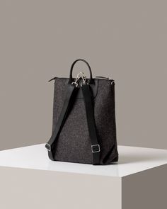 The Bedford Backpack's unique three-way design shows off the sculptural quality of felt as well as Merino wool felt's natural durability. Detachable straps convert the Bedford from backpack (https://graflantz.com/collections/backpack) to shoulder tote in seconds. Features include an interior zippered felt pocket, smooth leather trim, and nickel hardware.

 Also available in a mini (https://graf-lantz.com/products/bedford-backpack-mini-granite-felt-sienna-leather) version for a smaller frame or lighter load

 To add a little extra flare and make your bag even more unique, why not add one of our Fobs (https://graflantz.com/collections/keychains).

 
*Please Note: Gift Boxes are not available for this item



 Benefits of Merino Wool Felt

  
 * Sustainable, biodegradable, and renewable 
 * O Modern Backpack With Leather Trim For On-the-go, Business Backpack With Leather Trim, Daily Use Rectangular Backpack With Leather Trim, Functional Everyday Backpack With Leather Handles, Everyday Leather Trim Backpack, Functional Leather Trim Backpack For Daily Use, Modern Backpack With Leather Trim, Functional Backpack With Leather Trim For Daily Use, Everyday Backpack With Leather Trim