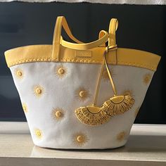 This Adorable Beach Bag Is Hard To Let Go Of Because It’s So Cuuuuute. Beautiful Sun Embroidered Tote Perfect For Warm Weather And Coastal Outings. New With Tags But They Are Tucked In The Pocket Because They Were Unattached When I Purchased The Bag Gold-Plated Hardware Open Top Tie Closure Interior Zip Pocket & Slip Pocket Approx. 12.5" X 20.5" X 6.4" Bag; 11.5" Handle Drop Yellow Top Handle Shoulder Bag For Vacation, Summer Yellow Canvas Shoulder Bag, Luxury Yellow Bag With Braided Handles, Luxury Yellow Bags With Braided Handles, Yellow Top Handle Beach Bag, Yellow Luxury Bag For Spring, Yellow Luxury Spring Bag, Luxury Yellow Spring Bag, Kate Spade Summer Travel Shoulder Bag