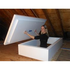 a woman standing in an open white box