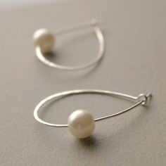 Classic and oh-so-feminine pearl hoop earrings in sterling silver will take your fashion all over town. Always stylish, these are a must have staple. Hoop earrings are hand made to order in sterling silver. {DETAILS}: * Hoops measure roughly 1 inch tall and .75 inch wide at the Everyday Hoop Earrings With Pearl Charm In Sterling Silver, Dainty Sterling Silver Hoop Earrings With Pearl Charm, Small Hoop Sterling Silver Earrings With Pearl Charm, Sterling Silver Hoop Earrings With Pearl Drop For Everyday, Delicate Sterling Silver Hoop Earrings With Pearl Drop, Everyday Sterling Silver Hoop Earrings With Pearl Drop, Minimalist Silver Hoop Pearl Earrings, Everyday Small Hoop Sterling Silver Pearl Earrings, Sterling Silver Small Hoop Pearl Earrings For Everyday