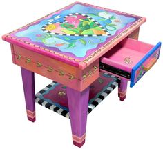 an artisticly painted wooden table with drawers on the bottom and one drawer at the top