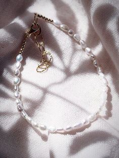 This beaded anklet features a collection of tiny white freshwater pearls to capture the enticement of Hawaii’s white sand beaches. Wear this gold pearl anklet alone or stacked for a classically elegant allure. ✦ DETAILS ✦✧ Name: Maile (MIE-leh) - vine.✧ Adjustable Length up to 10" Inches.✧ White 2-3mm Freshwater Pearls.✧ 14kt Gold Filled Components, Extender, and Clasp.✧ All Ke Aloha Jewelry pieces come packaged thoughtfully, beautifully, and ready for gift giving. Elegant Pearl Bracelet As Summer Gift, Elegant Gold Pearl Bracelet For Summer, Elegant Summer Pearl Bracelet As Gift, Elegant Summer Pearl Bracelet For Gift, Elegant White Pearl Bracelet For Summer, Tiny Beads Pearl Bracelet, Elegant Beaded Pearl Bracelet For Summer, Elegant Adjustable Pearl Anklets, Elegant Pearl Bracelet With Round Beads For Summer