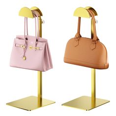 two purses sitting on top of metal stands