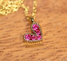 Tiny heart necklace - pink heart necklace - gold heart necklace - love necklace - bff necklace An itty bitty magenta pink heart having happily from a 14k gold vermeil chain at the length of your choice! This tiny, gold plated brass heart holds 5 sparkly crystals. Heart measurement: 8mm Looking for other charm necklaces? https://www.etsy.com/shop/BubuRuby?section_id=12318467 More from Bubu Ruby? https://www.etsy.com/shop/BubuRuby?ref=si_shop ♥ Handmade with love in sunny California ♥ These gems w Sparkly Crystals, Heart Necklace Gold, Pink Heart Necklace, Bff Necklace, Tiny Heart Necklace, Bff Necklaces, Necklace Love, Sunny California, Gold Heart Necklace