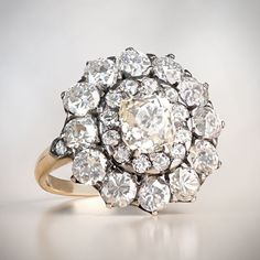 an antique diamond cluster ring on a white background