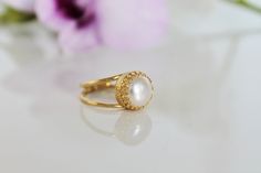 Anemone Jewerly Elegant Gold Birthstone Wedding Ring, Handmade Oval Wedding Rings, Gold Flower Ring With Birthstone For Wedding, Heirloom White Birthstone Ring For Wedding, Delicate Flower Ring With Gemstone For Wedding, Elegant Filigree Birthstone Ring For Anniversary, Pearl Halo Ring For Wedding With Round Cut, Delicate Halo Wedding Rings, Adjustable Round Flower Ring For Wedding