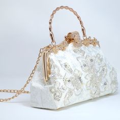 New to our Millennium collection, This beautiful romantic WHITE Embroidered FLORAL bridal clutch bag is made of very fine quality of fabric and metal and it comes with a two long Detachable chain one is pearl chain and other is metal chain of your choice for your Big day! Dimensions- length oh the bag is 9 inches and Height of the bag is 6 inches and 3 inches wide. Pearl chain measure about 43 inches and Gold Metal chain about 47 inches long. ► ABOUT YOUR ORDER * All items are neatly packaged in White Top Handle Evening Bag For Formal Events, Elegant Top Handle Shoulder Bag For Wedding, Elegant Embroidered Handheld Evening Bag, Elegant Cream Bag For Ceremonies, Gold Top Handle Shoulder Bag For Wedding, Luxury Evening Bag With Removable Pouch For Wedding, Wedding Shoulder Bag With Detachable Top Handle, White Rectangular Evening Bag For Wedding, Elegant Embroidered Evening Bag For Wedding