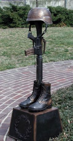 a pair of boots that are on top of a statue