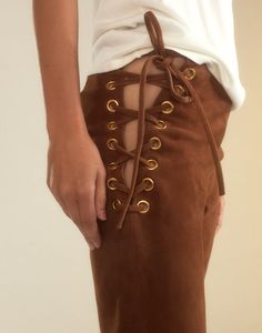 Straight leg lace-up pants in brown suede Premium suede Straight-leg silhouette High rise Adjustable lace-up sides with gold eyelets Rich caramel brown Fabric content: 100% leather Care instructions: dry clean only Fit: model is 5'10" and wears a size 4. Size 4 measurements: Length: 44" Complete the look: Mica Sleeveless Knit Top Suede Pants Outfit, Color Leather Pants, Brown Leather Pants, Suede Top, Suede Pants, Sleeveless Knit Top, Knit Alpaca, Sleeveless Knit, Favorite Daughter