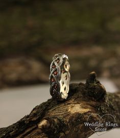 a wedding ring sitting on top of a tree branch