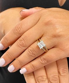 a woman's hand with a diamond ring on it