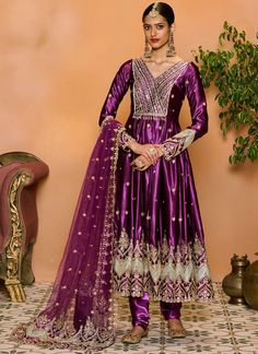 Purple Embroidered Satin Anarkali Anarkali Churidar With Mirror Work In Raw Silk, Floor-length Dola Silk Churidar With Mirror Work, Designer Dabka Churidar For Party, Party Wear Churidar With Dabka For Eid, Eid Party Wear Churidar With Dabka, Anarkali Traditional Wear In Katan Silk With Dabka Detailing, Anarkali Churidar In Chinon For Eid, Anarkali Style Chinon Churidar For Eid, Chinon Anarkali Churidar For Eid