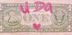 a one dollar bill with pink writing on it