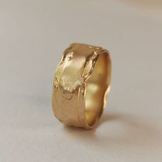 a gold ring with a rough surface on it