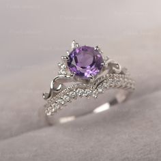 * The delicate ring displays amethyst as main stone. The curved band beneath the gemstone makes the ring like an elegant crown. For who wearing this dainty ring, will shine like a queen. ◆ Production Description: Main stone Type: Amethyst Main Stone Shape: Round Cut Main Stone Size: 7*7mm Side stone: CZ Metal: 925 Sterling silver - Other options available in the drop down menu ◆ Customization: √Free for Add Engraving √Other Metal Type Available √Other Gemstones & Shapes Available √Personaliz Luxury Amethyst Ring With Accent Stones For Promise, Elegant Lavender Amethyst Ring Luxury, Elegant Amethyst Crystal Ring With Center Stone, Elegant Amethyst Crystal Ring With Accent Stones, Elegant Amethyst Birthstone Crystal Ring, Elegant Amethyst Birthstone Diamond Ring, Dainty Amethyst Wedding Ring With Prong Setting, Elegant Amethyst Birthstone Ring In Cubic Zirconia, Elegant Purple Birthstone Ring With Round Cut