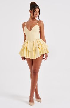 Wear this pretty playsuit on repeat, cut from our premium chiffon which is super floaty and lightweight. Featuring a layered ruffle skirt with built in shorts, this plunge neck design is backless with adjustable straps for your perfect fit. Partner with barely there heeled sandals and a bright bag. 



Colour: Lemon.

Premium non-stretch chiffon.

Fully lined.

Layered ruffle skirt with built in shorts.

Plunge neckline.

Adjustable straps.

Internal tie at waist.

Backless design.

Invisible zi Homecoming Dresses Corset, Midi Dress Wedding Guest, Layered Ruffle Skirt, Bright Bag, Eve Dresses, Maxi Dress Sale, Sparkle Dress, Backless Design, Plunge Neckline