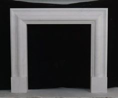 an empty white fireplace with black background