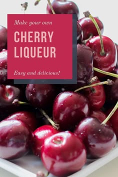 a white plate topped with lots of cherries next to a pink sign that says make your own cherry liquor easy and delicious