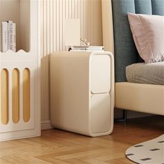 a white cabinet sitting next to a bed on top of a hard wood floor in a bedroom