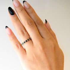 This gorgeous band takes a favorite eternity setting of Anna Sheffield's and makes it utterly modern. Round black diamonds encircle the finger in delicate bead-set and rhodium-plated box settings, each adding stunning contrast to a classic design. Wear this ring as a stacker on any finger, or pair it with an engagement ring for a match that's made to last. Designed in New York. 14 karat yellow gold with round black diamonds. Modern Jewelry With Single Cut Diamonds In Round Band, Minimalist Black Diamond Jewelry As Gift, Minimalist Black Diamond Jewelry For Gift, Minimalist Black Diamond Jewelry Gift, Classic Eternity Band With Bezel Setting As Gift, Classic Bezel Set Eternity Band As Gift, Elegant Rings With Black Diamonds, Modern Diamond Ring With Black Diamonds For Gift, Modern Diamond Ring With Black Diamonds As A Gift