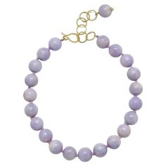 Striking strand of uniform Lavender Jade Beads, 19.5 - 20mm with an 18k gold* handmade clasp. The decorative oval link 2" extender, with its drop bead, allows for the necklace to be worn with the clasp in the front for a fun and stylish look. *In Faye Kim's signature 18k green gold, an alloy comprising 75% pure gold and 25% silver. Customizable in other precious metals and finishes. Length 18" + 2" extension Made in the USA Luxury Purple Jewelry With Round Beads, Elegant Purple Necklace With Large Beads, Elegant Lavender Beaded Bracelets, Elegant Necklace With Large Oval Beads, Elegant Oval Jewelry With Large Beads, Classic Purple Round Bead Jewelry, Elegant Lavender Jewelry With Round Beads, Elegant Lavender Necklaces With Gemstone Beads, Elegant Single Strand Lavender Necklace