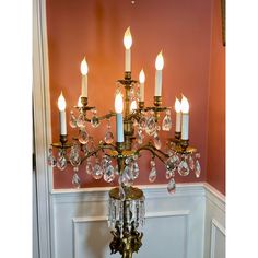 a chandelier with many lights on it in a room next to a wall