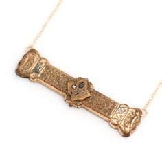 A gold-filled antique bar pin from the Victorian era (circa mid/late 1800s to early 1900s) has been repurposed as a necklace to be more wearable today. This piece of history shows wear from its storied past. Bar pin conversion measures approximately 2 1/4" x 1/2”. New 14k gold-filled chain. Overall necklace length is 16”. Bar pin pendant adds to overall necklace length. If desired, an adjustable chain length may be built into the existing chain to be more versatile, adjustable from 16-17-18 inch Historical Yellow Gold Engraved Jewelry, Antique Engraved Necklace With Rectangular Pendant, Antique Engraved Rectangular Pendant Necklace, Historical Gold Medallion Jewelry, Vintage Yellow Gold Necklace With Rectangular Pendant, Vintage Engraved Rectangular Pendant Necklace, Antique Gold Necklace With Rectangular Pendant, Historical Gold Jewelry For Weddings, Vintage Jewelry With Rectangular Pendant Charm