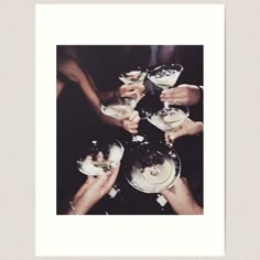 a group of people holding wine glasses in their hands