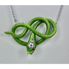 This is part of Chairish’s Fine Jewelry assortment.  Victorian Green Enamel Snake Pendant 18K  This gorgeous Victorian Enamel Snake Pendant is unusual in color and the fact that this is not a brooch but a pendant makes it more so. There are 2 hooks to place a chain that are slightly hidden. You can always add a pin to make this a brooch but I just love it on a chain. I photographed this piece with a Platinum chain, but a yellow gold chain will work just as nicely. This piece weights in at 20.9 g Unique Enamel Jewelry As Gift, Elegant Green Snake-shaped Jewelry, Luxury Green Brooch Jewelry, Green Sterling Silver Brooch Jewelry, Green Sterling Silver Brooch, Sterling Silver Green Brooch, Luxury Handmade Enamel Jewelry, Luxury Green Enamel Jewelry, Enamel Brooch Pendant Jewelry