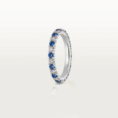 a white gold ring with blue sapphires and diamonds on the sides, set in 18k white gold