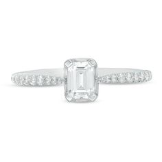 Sleek and chic, this sparkling diamond engagement ring appeals to her sophisticated sense of style. Crafted in 14K white gold, this exquisite design features a 1/2 ct. emerald-cut diamond wrapped in a shimmering frame of baguette-cut diamonds. Along the pinched shank, round diamonds in graduated sizes fortify the streamlined look. Radiant with 3/4 ct. t.w. of diamonds and a brilliant buffed luster, this engagement ring honours your bride-to-be. Due to the nature of pre-owned jewellery, the ring you choose may have been previously sized. Ring styles from our pre-owned jewelry inventory are sold at their current size and cannot be resized at purchase. As this inventory constantly changes, we are unable to state or guarantee the size of any pre-owned ring. White Gold Diamond Ring With Vvs Clarity Baguette Cut, White Gold Baguette Cut Lab Grown Diamond Ring, White Radiant Cut Rings With Diamond Cut, Timeless White Lab Grown Diamond Ring, Promise Solitaire Baguette Cut Diamond Ring, Radiant Cut Diamond Ring In 14k White Gold, Emerald Cut Diamond Ring With Accents For Proposal, White Princess Cut Diamond Ring In Platinum, Baguette Cut Solitaire Diamond Ring For Promise