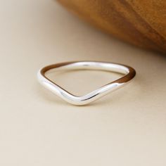 Forged by hand in solid sterling silver, the Chevron Ring features a rounded V-shape center for a striking focal point on the finger. To make this unisex band, raw silver is milled to a thick gauge and hammered around stakes to form its smooth curves. The interior of the band is domed for a comfortable fit. This ring is made-to-order by hand in our bespoke metalsmithing studio in Stockport, New York. Instead of casting multiples of our designs, we fabricate each element by hand the old-school way using torches, hammers, and files on raw silver. Therefore, each ring is truly handmade and one-of-a-kind. Details: - Solid sterling silver - Available in sizes 5-12 Please allow up to three business days for the creation of your ring. Chevron Ring, Hand Forged, V Shape, Focal Point, Band Rings, Old School, Bespoke, Jewelry Rings, Comfort Fit