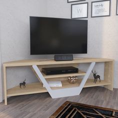 a flat screen tv sitting on top of a wooden entertainment center in a living room