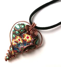 Very special and exceptional heart pendant/necklace handmade and personally designed. Handmade heart is made of polymer clay with a floral motif. The heart is made of handmade polymerclay canes. It is wrapped in copper wire. The black faux leather chain is adjustable in length from 25 to 28 cm with the addition of a copper chain. The coiled copper wire around the heart-shaped pendant gives it a special charm. Statement pendant/necklace in vibrant colours will be an exceptional and unique gift fo Wire Wrapped Polymer Clay Jewelry, Faux Leather Bracelets, Beaded Leather Wraps, Pendant Heart, Handmade Heart, Beaded Wrap Bracelets, Stone Pendant Necklace, Bead Leather, Leather Wrap Bracelet