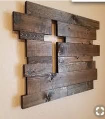 a wooden wall hanging on the side of a wall with two pieces of wood attached to it