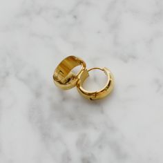 "Brand new. One of our everyday favorites! Made with clean and hypoallergenic 316L titanium. Dainty and simple design. They can be stacked up with any other earrings or ear cuffs. Beautiful gold finish. Material: 18k gold plated titanium and hypoallergenic titanium posts Diameter: 0.55\" / 1.4cm The width of the earring band: 0.27\" / 7mm Weight of one earring: 3.7g Q&A 1. What is the material? - It is made from 18K real gold plated titanium. Titanium is nickel-free, zinc-free and hypoallerg Minimalist Stainless Steel Tarnish Resistant Huggie Earrings, Minimalist Stainless Steel Hoop Earrings For Everyday, Classic Stainless Steel Huggie Hoop Earrings, Minimalist Hypoallergenic Hoop Earrings For Everyday, Everyday Stainless Steel Single Huggie Earring, Minimalist Hypoallergenic Cartilage Earrings For Everyday, Minimalist Hypoallergenic Everyday Cartilage Earrings, Modern Small Hoop Cartilage Earrings Tarnish Resistant, Minimalist Stainless Steel Huggie Earrings