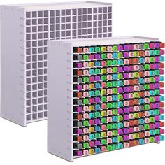 two white storage racks with multicolored squares on each side and one in the middle