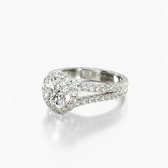 an oval shaped diamond engagement ring with split shans on the sides and shoulders, set in white gold