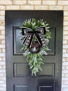 a christmas wreath on the front door of a house