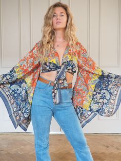 SILK BELL SLEEVE CROP TOP - RAINBOW FIRE SKY ** LIMITED PRINT AVAILABLE **  Handmade recycled silk crop kimono with amazing billowing bell sleeves and gold printed fabric! The gold shimmers and shines, the photos don't do it justice!  This incredible silk crop top is the perfect addition to any outfit, with flowing sleeves and bohemian vibe, this is an amazing bespoke piece to add to any wardrobe!  Our 'Bella' tops were dreamed up in the sunshine and are a twist on our classic 'Stevie' tops and Summer Bohemian Blouse With Batwing Sleeves, Bohemian Batwing Sleeve Blouse For Summer, Vintage V-neck Top With Boho Print, Multicolor Batwing Sleeve Tops For Spring, Bohemian Festival Top With Kimono Sleeves, Festival Boho Print Rayon Blouse, Bohemian Rayon Top With Boho Print, Bohemian Multicolor Blouse With Kimono Sleeves, Bohemian Boho Print Rayon Tops