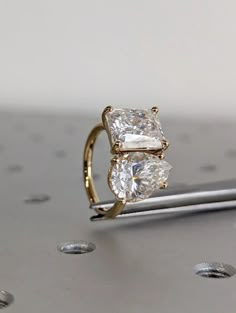 three stone ring sitting on top of a table