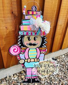 a wooden sign with a nutcracker figure on it's face and name