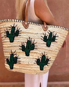 This straw tote is handcrafted in Morocco with love, each is a unique work of art. Perfect for the beach, the market, or wherever your day takes you. Accented with durable, genuine leather straps. Versatile and spacious design. Embroidered cactus design Embroidered Natural Straw Travel Bag, Embroidered Natural Bags For Vacation, Embroidered Straw Tote Bag For Travel, Casual Embroidered Natural Bag, Embroidered Natural Beach Bag For Vacation, Bohemian Embroidered Straw Tote Bag, Casual Embroidered Straw Tote Bag, Bohemian Natural Embroidered Straw Bag, Embroidered Beach Straw Tote Bag