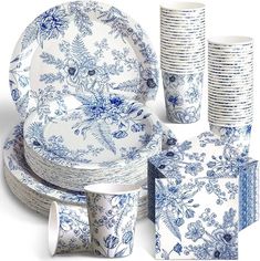 a blue and white dinnerware set with matching cups, plates, and napkins