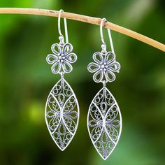 Thai artisan Lalana exalts the beauty of fine filigree work. Handcrafted rope patterns in sterling silver fill two eye-shaped segments that dangle below elegant daisies. Elegant Sterling Silver Earrings For Spring, Elegant Flower Shaped Jewelry For Summer, Spring Teardrop Jewelry, Elegant Summer Flower-shaped Jewelry, Silver Filigree Dangle Flower Earrings, Silver Drop Earrings For Spring, Elegant Pierced Jewelry For Summer, Elegant Sterling Silver Spring Jewelry, Elegant Silver Flower Earrings For Summer