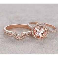 two wedding rings with an orange diamond in the center and white diamonds on each band