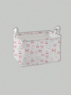 a white and pink bag with minnie mouses on it, hanging from the side